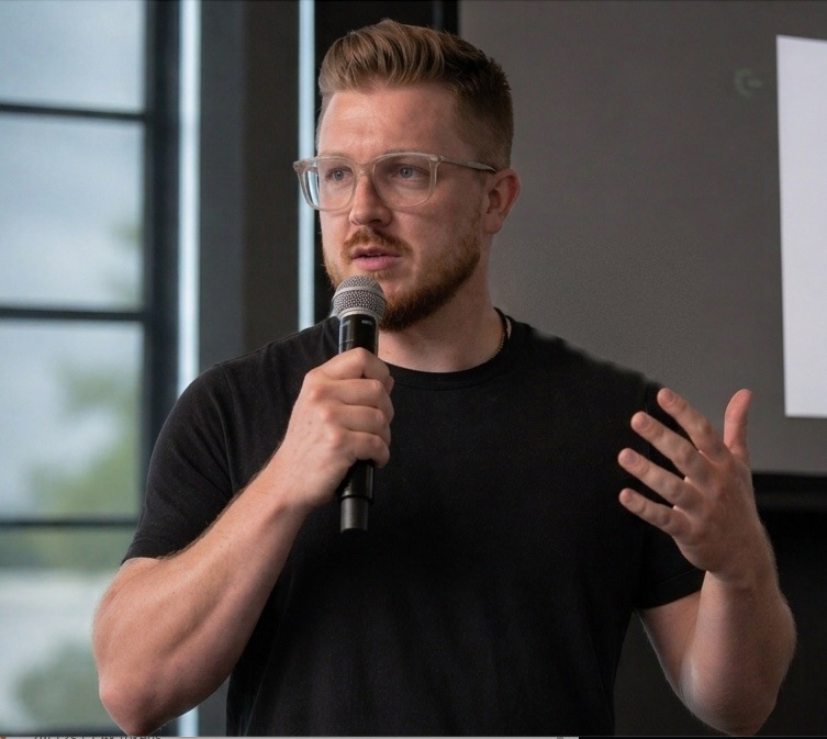Mitch Conquer speaking on stage